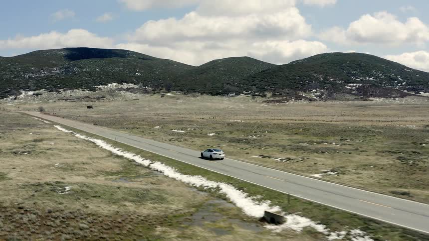 An electric car being driven on a mountain road