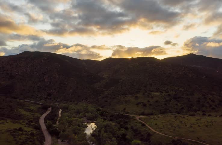Time lapse of a river running through the hills