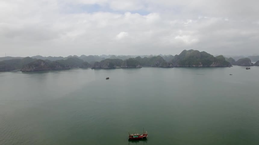 Boats floating on a lake in front of hills