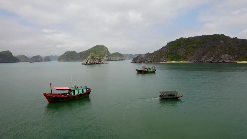 Boats travel among islands on cloudy day