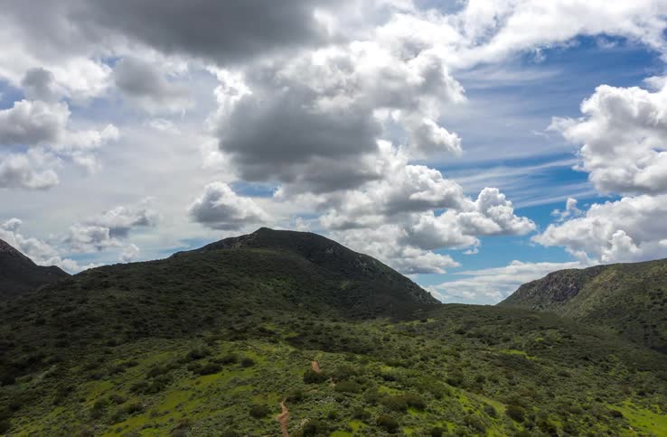 The clouds flow over the mountains giving off shade