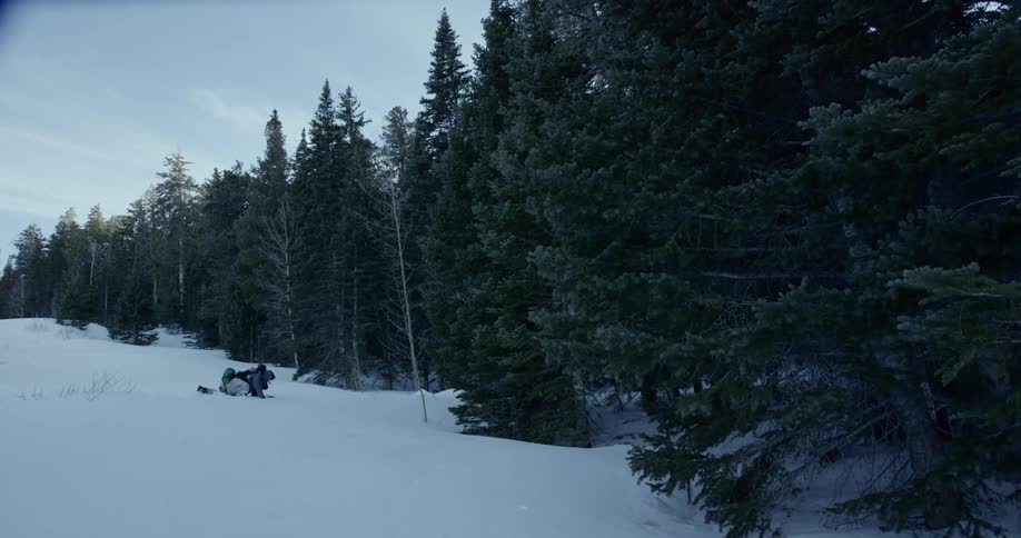 Injured person laying on the snow in the mountains