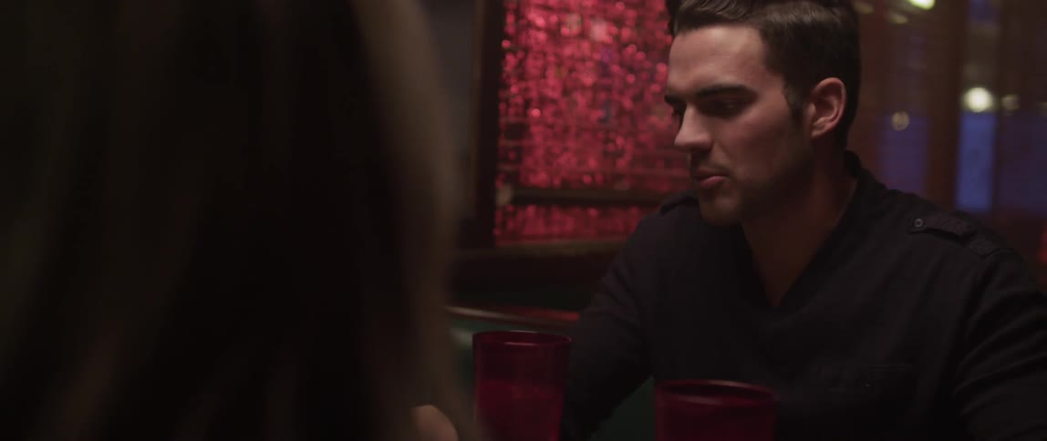 A man and woman chat at a restaurant table