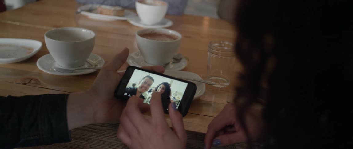 A man and woman take a selfie in a restaurant