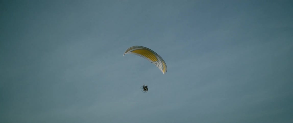 A person parachuting on a cloudy day
