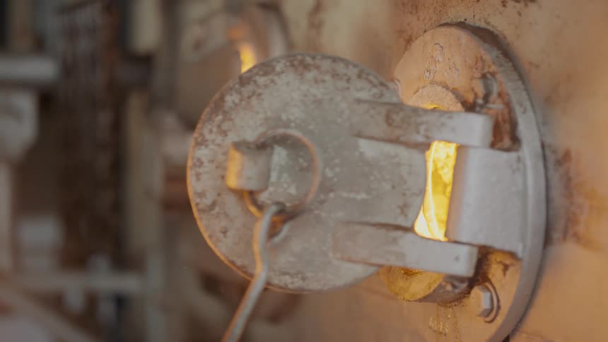 A lid to a furnace being opened