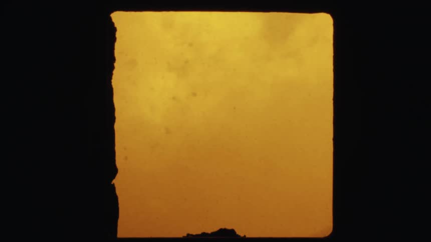 A window with smoke and ash blowing outside
