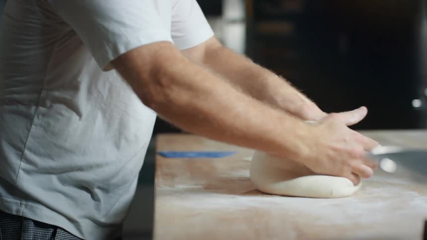 Person kneading dough on a counter top