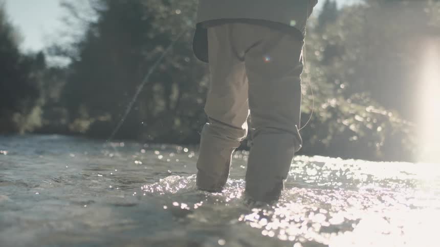 Man casts a fishing line in the river