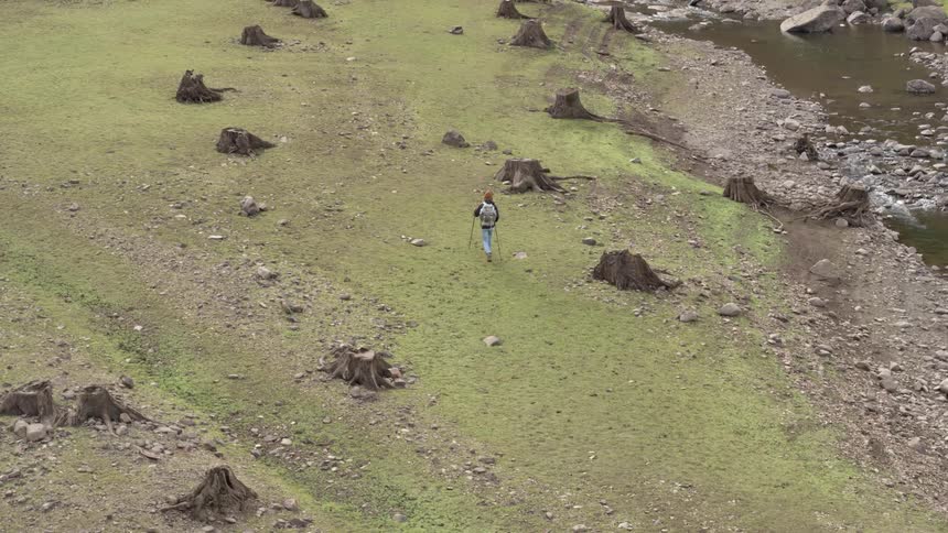 A man is hiking up the hill