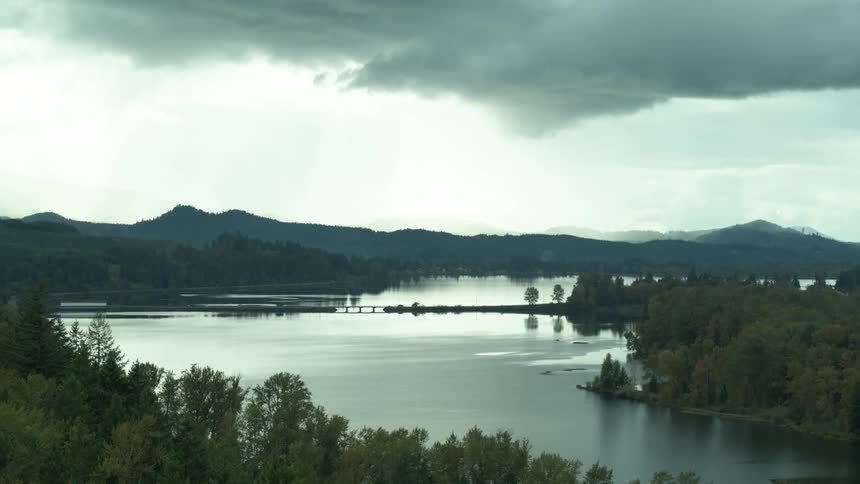 The river near the mountain is empty and calm