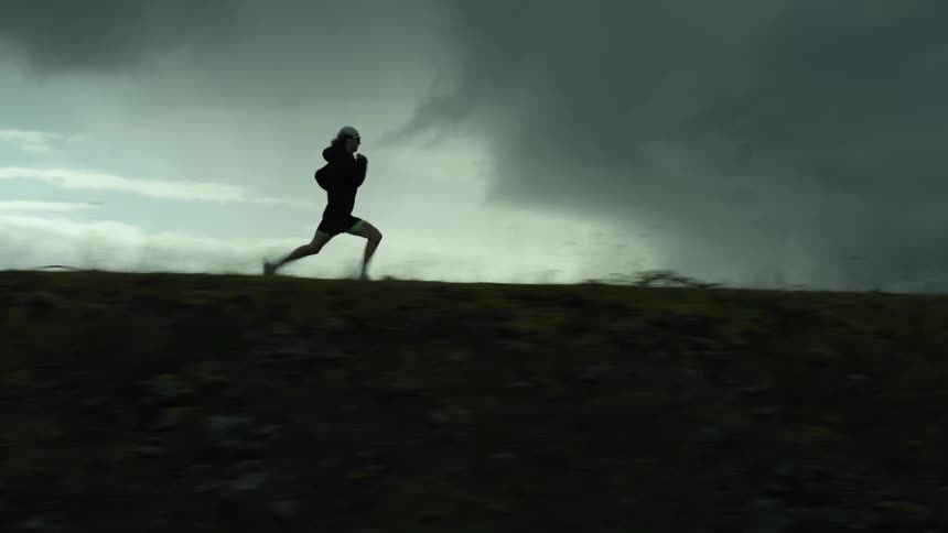 A person is running outdoors at dusk