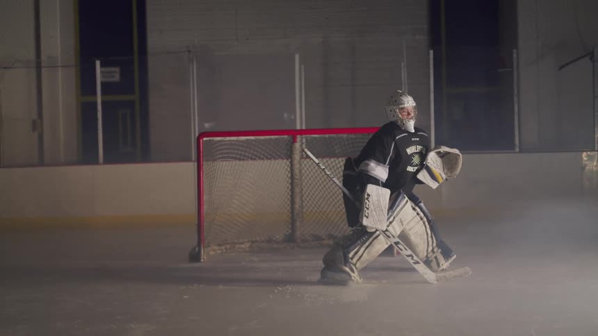 A goalie goes to block the puck