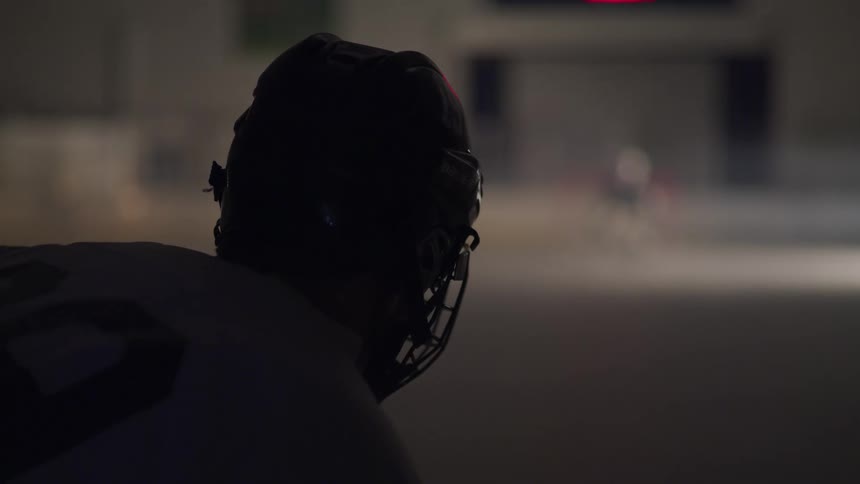 Two hockey players stare at each other in an empty ice arena