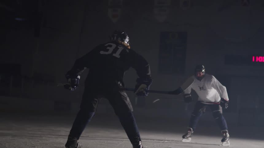 Hockey skaters come face to face during the game in the ice hockey rink