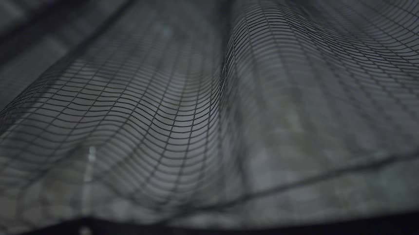 Canvas covered in a grid rotates against black background