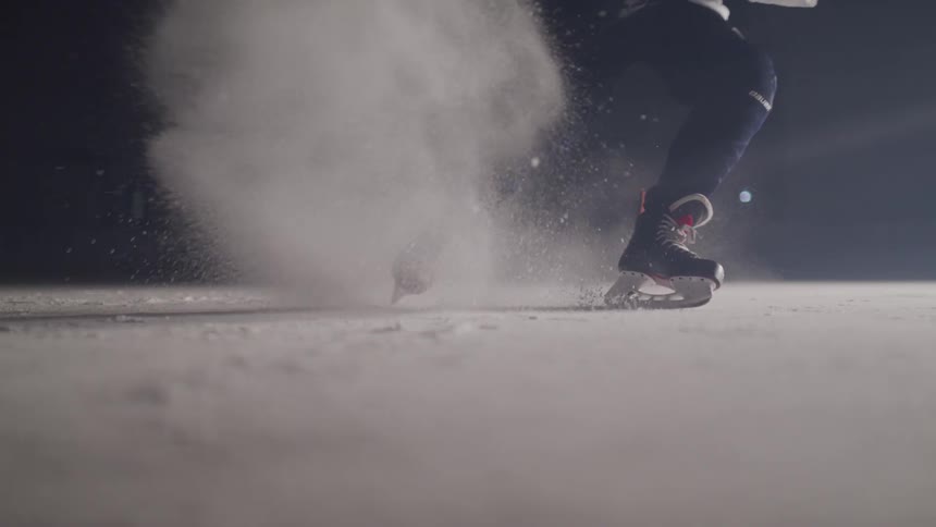 A hockey player slides in the ice