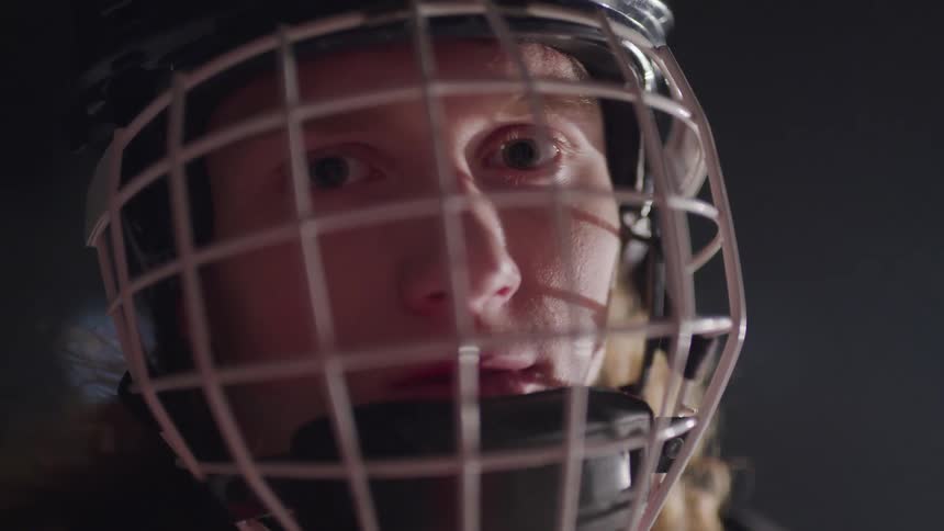 Sports player wears a helmet with an attached face protector