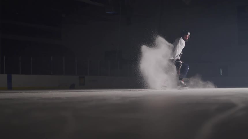 Hockey player skates on the ice in the ice hockey rink