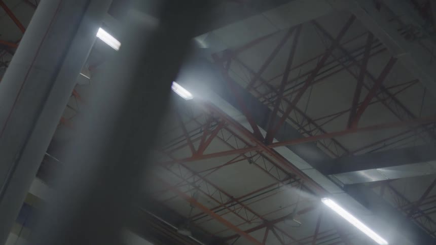 Red rafters cover the ceiling of a gymnasium