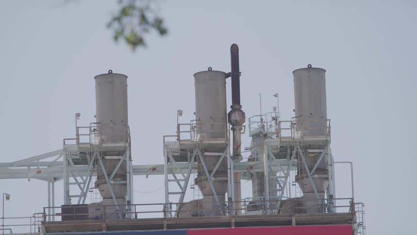 Towers sit on a platform at a power plant