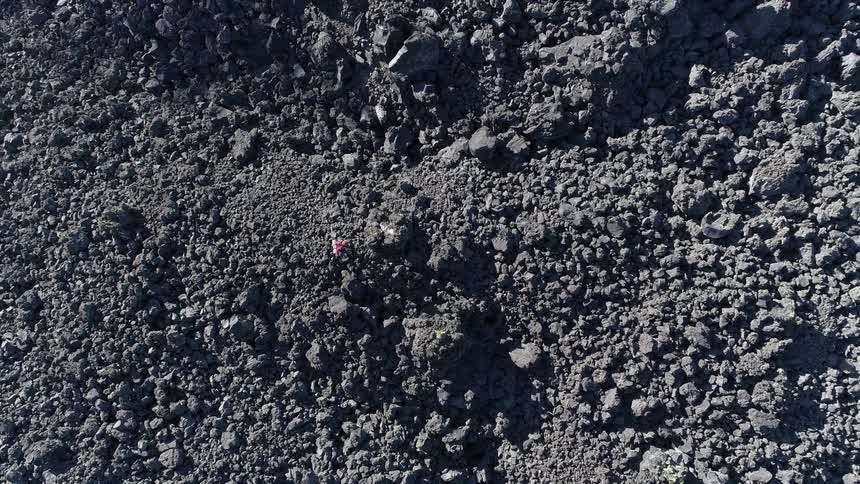 Person walks across uneven terrain
