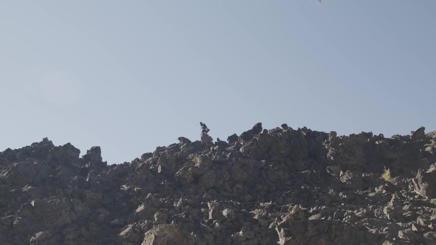 Man hiking on top of big rocks