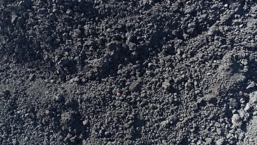 Birds eye view of a person hiking over rocky ground