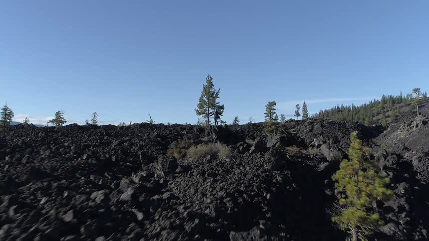 The person stands high on the rock