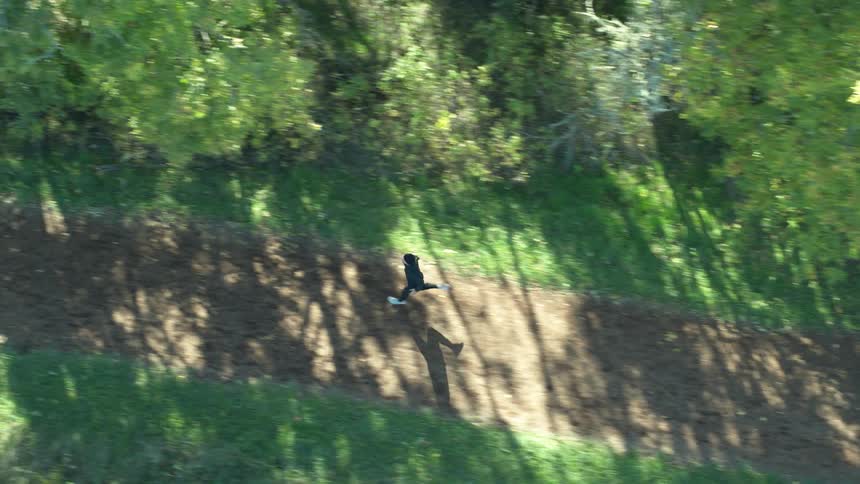 A man runs along a rural dirt pathway