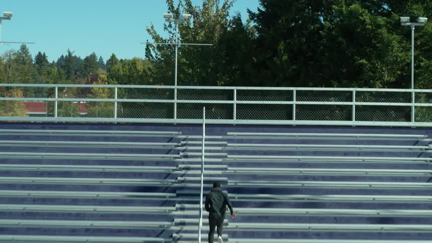 A person exercising running up bleachers