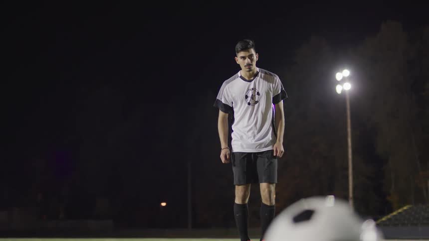 A man gets ready to kick a soccer ball