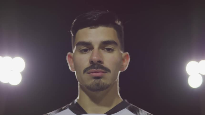 White soccer player standing in the middle of a field