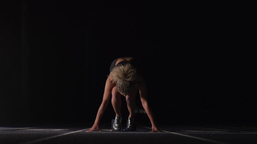 A female at the starting line getting ready to run