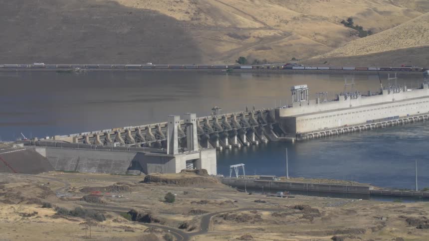 Dam creates lake among hilly terrain