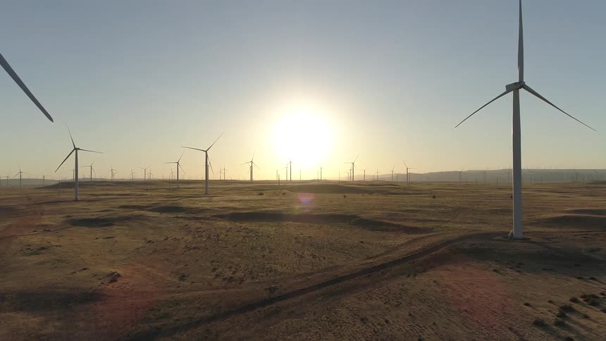 Aerial view of wind turbines on the plains at dusk