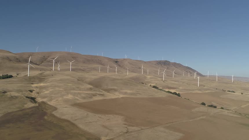 The hills ahead are lined with windmills