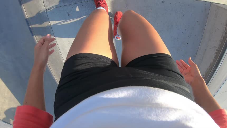 Point of view shot of a female roller skating at a skate park