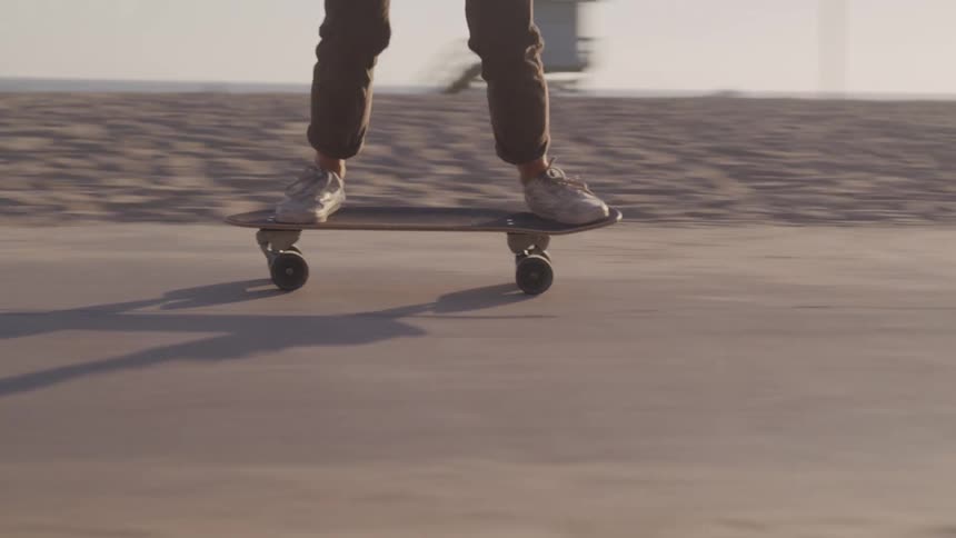 Person skating through the sidewalk on the beach