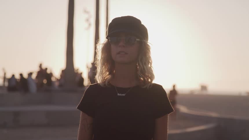 A blonde haired woman posing at low sun