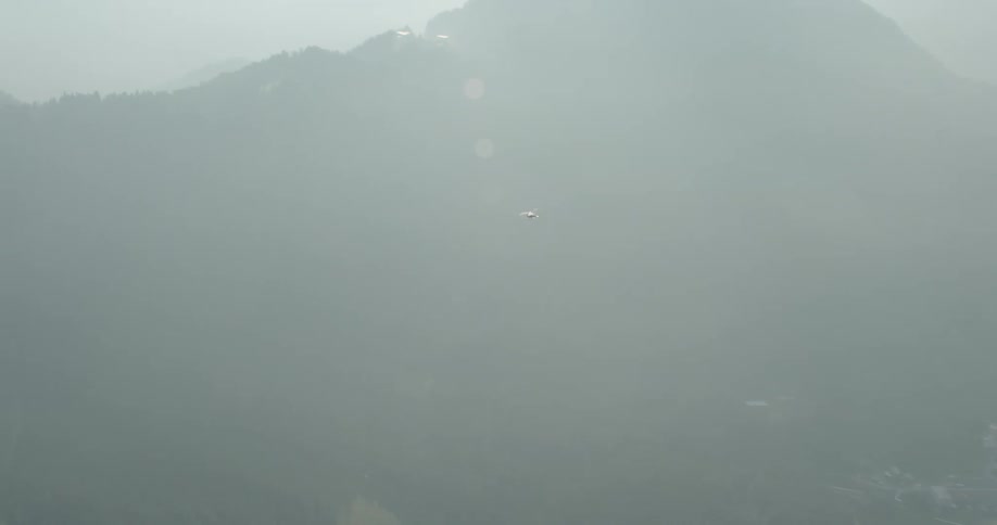 Fog obscures town and surrounding mountains