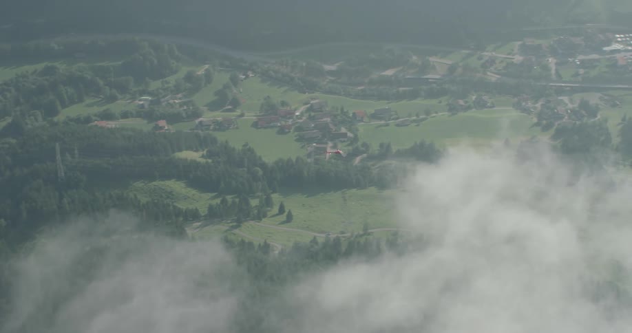 A helicopter flying over land and buildings