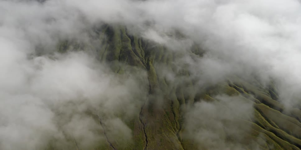 Clouds float over a mountainous area