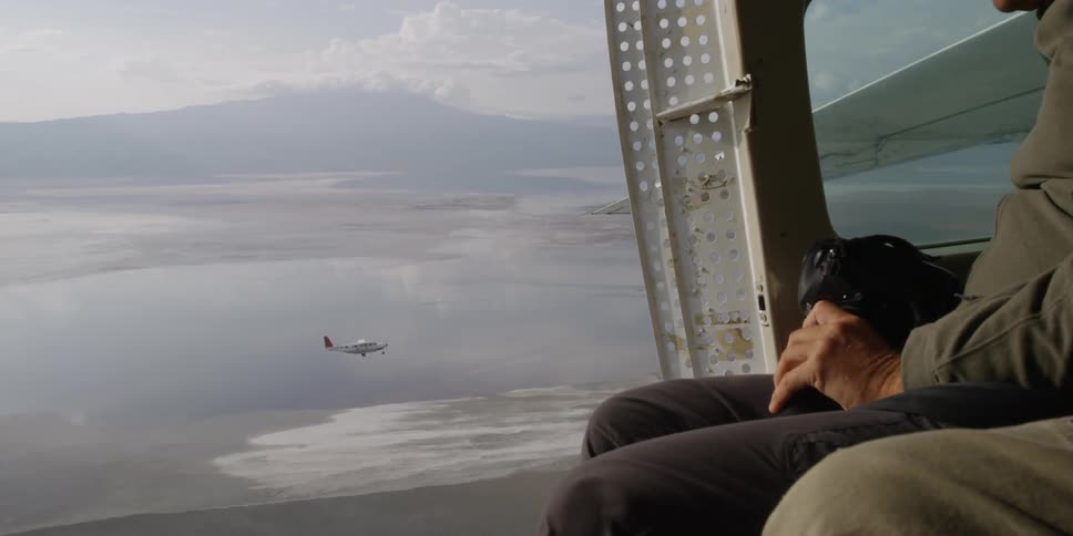 Photographers In Airplane Over African Wetlands