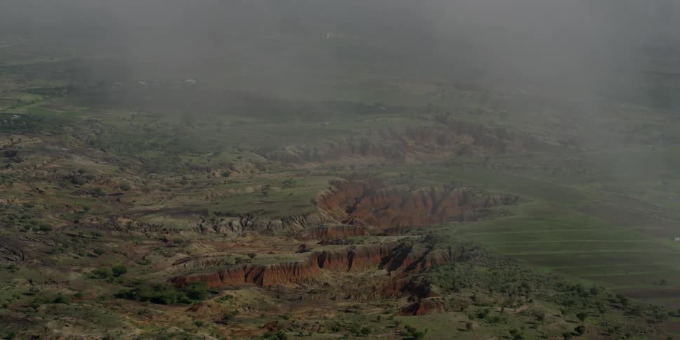 Mist over green, rocky hills