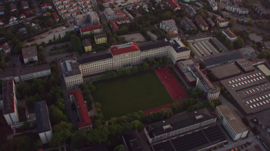 A field in the center of a campus in a city