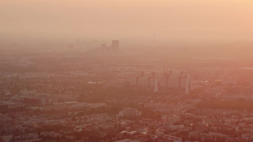An aerial view of a downtown city is displayed at dusk