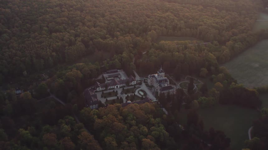Aerial view of a mansion in the countryside at dusk