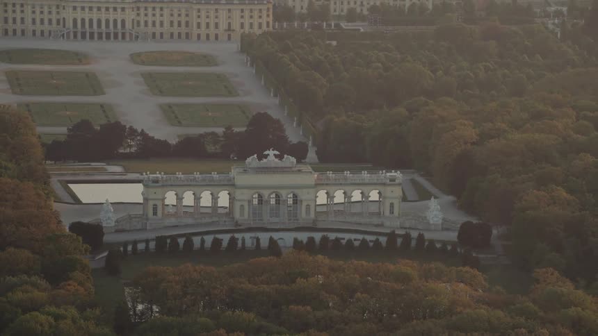 A large building and architecture with statues on it in a city