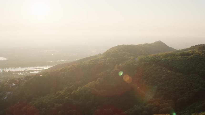 Aerial view of the green mountains and the river next to the city vienna